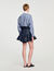 Gonna corta in denim con volant