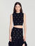 Top in maglia con borchie