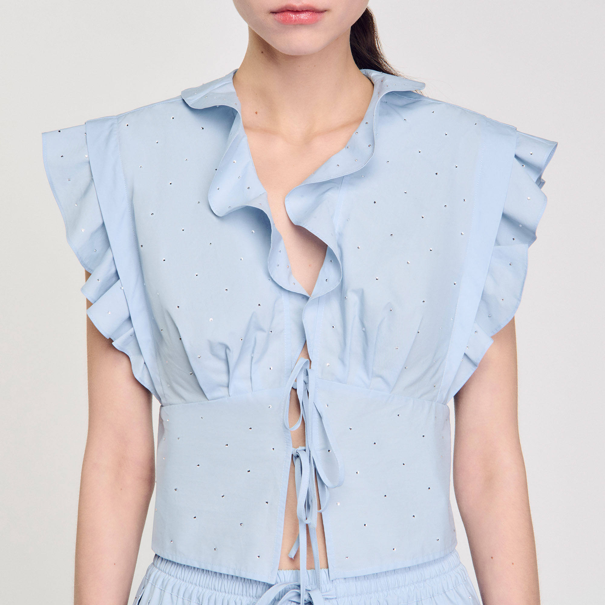 Top glitterato con volant